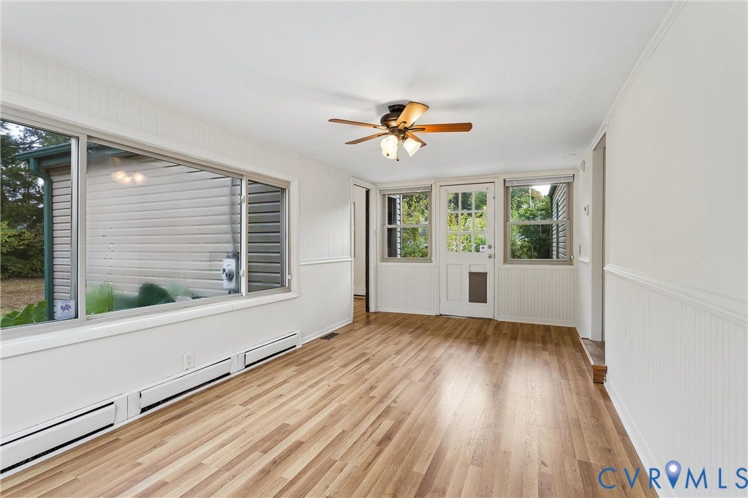 627 Sedgefield Drive, 992- All Others Area 107, Newport News, VA 23605 Bright interior featuring wood-finish flooring, wainscoting, a ceiling fan with integrated lighting, and a multi-pane glass entry door