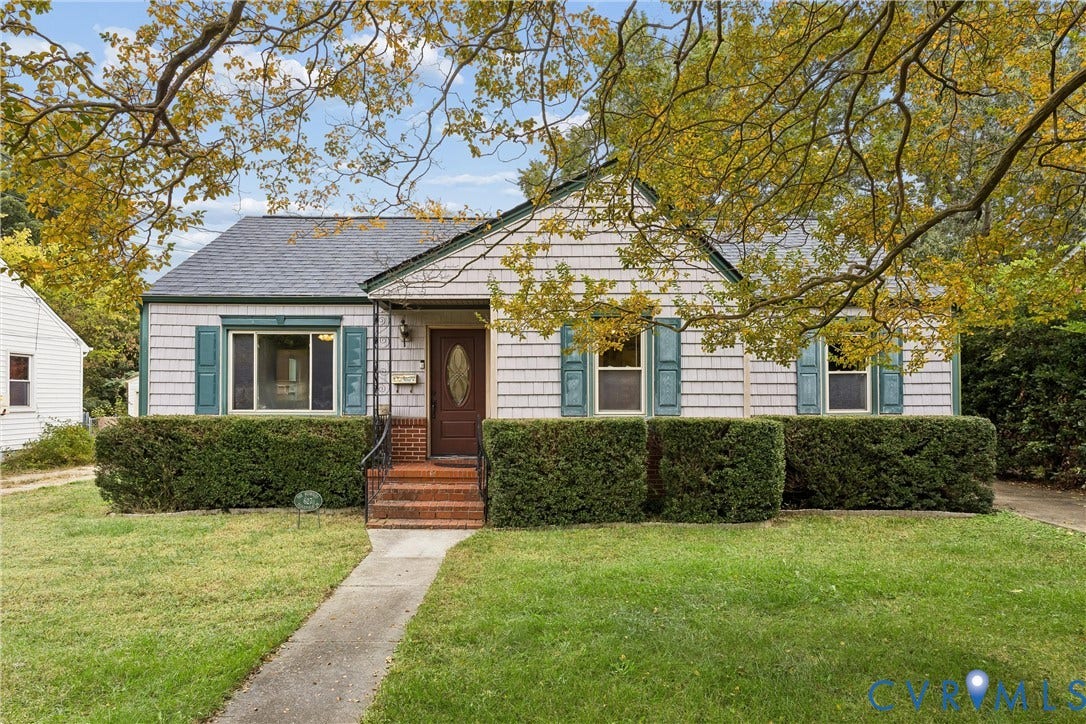 627 Sedgefield Drive, 992- All Others Area 107, Newport News, VA 23605 Single-story residence featuring light-colored shingle siding, decorative green shutters, a central entrance with a brick staircase, and a concrete walkway