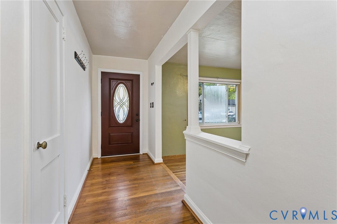 627 Sedgefield Drive, 992- All Others Area 107, Newport News, VA 23605 Entryway featuring wood-finish flooring, a solid core door with an oval glass insert, and a partial wall with a structural column