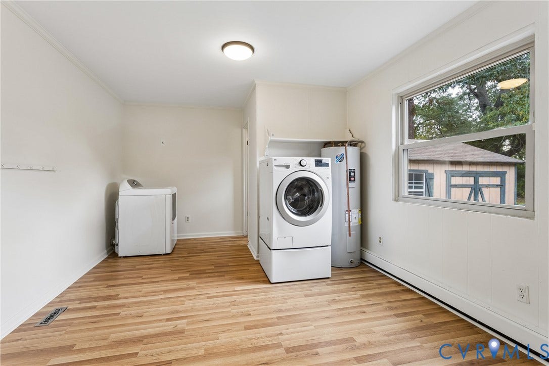 627 Sedgefield Drive, 992- All Others Area 107, Newport News, VA 23605 Laundry area featuring wood-finish flooring, a built-in shelf, and a large horizontal window