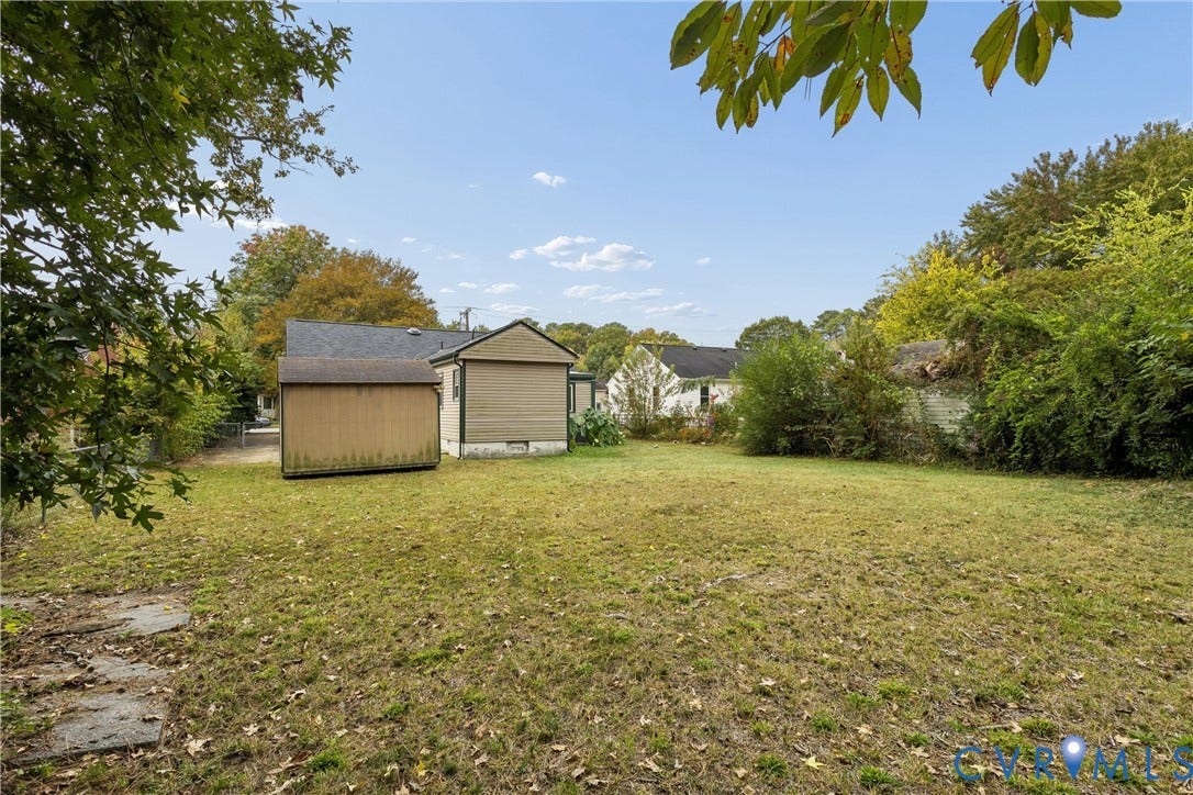 627 Sedgefield Drive, 992- All Others Area 107, Newport News, VA 23605 Expansive backyard featuring a level lawn, mature trees, and a detached storage structure