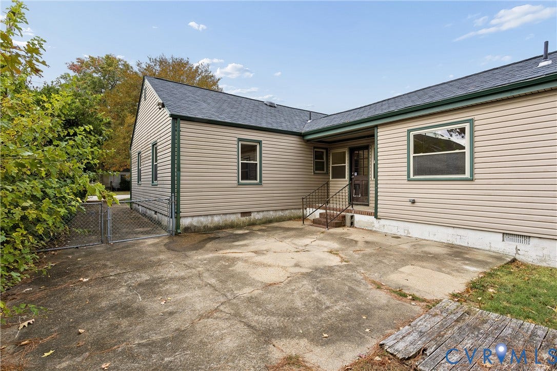 627 Sedgefield Drive, 992- All Others Area 107, Newport News, VA 23605 Exterior rear elevation featuring horizontal siding, a concrete patio, dark-framed windows, and metal staircase railing