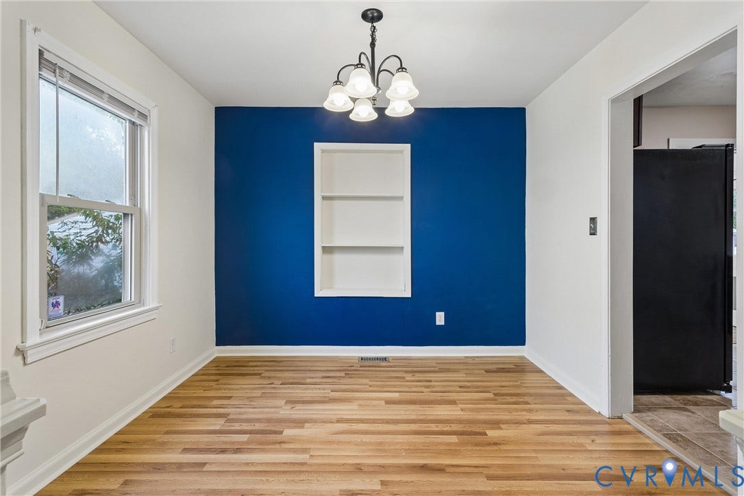 627 Sedgefield Drive, 992- All Others Area 107, Newport News, VA 23605 Wood-finish flooring, accent wall with built-in recessed shelving, and five-light chandelier