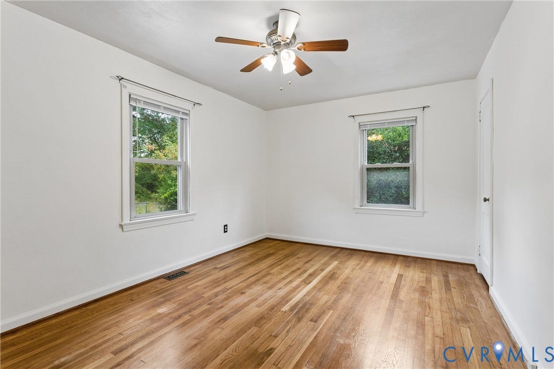 627 Sedgefield Drive, 992- All Others Area 107, Newport News, VA 23605 Interior room featuring wood-finish flooring, two double-hung windows, and a ceiling-mounted light fixture with a fan
