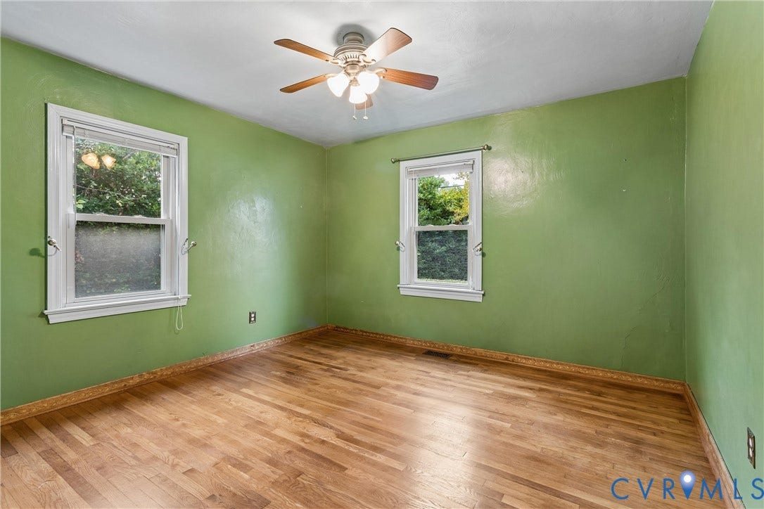 627 Sedgefield Drive, 992- All Others Area 107, Newport News, VA 23605 Interior room featuring wood-finish flooring, two double-hung windows with white casing, and a three-blade ceiling fan with integrated lighting