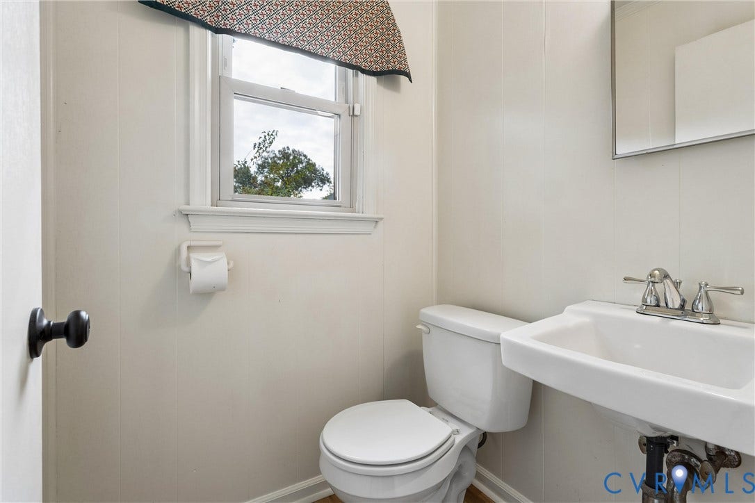 627 Sedgefield Drive, 992- All Others Area 107, Newport News, VA 23605 Wall-mounted mirror, white ceramic pedestal sink with polished metal faucet, and single-hung window with casing