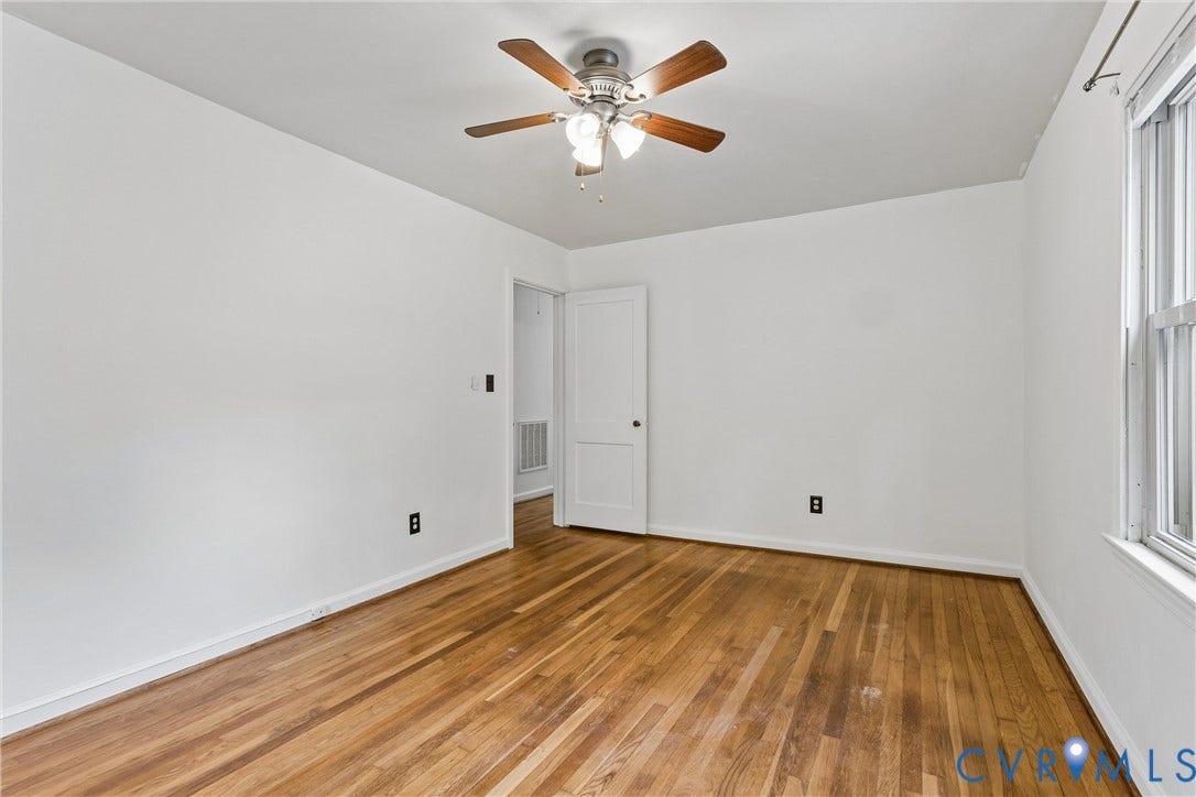 627 Sedgefield Drive, 992- All Others Area 107, Newport News, VA 23605 Room featuring wood-finish flooring, a multi-blade ceiling fan with integrated lighting, and a paneled interior door
