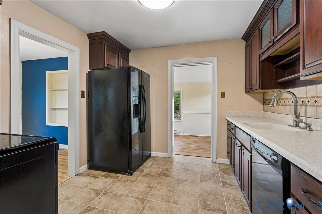 627 Sedgefield Drive, 992- All Others Area 107, Newport News, VA 23605 Kitchen featuring dark wood cabinetry, light stone-finish countertops, tiled backsplash, integrated sink with gooseneck faucet, and tile flooring