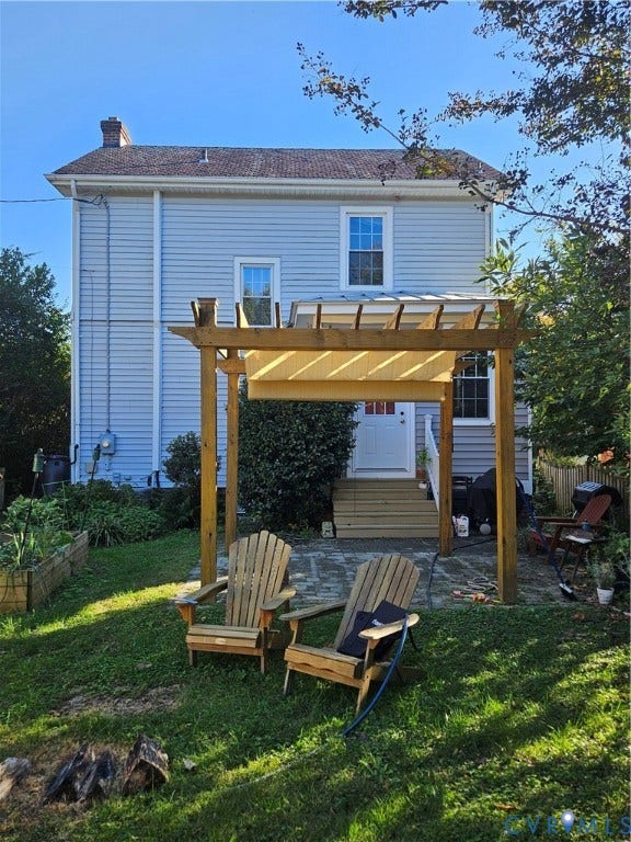 1206 Westminster Avenue, Richmond, VA 23227 Two-story residence with light-colored siding, flagstone patio, and wooden pergola structure