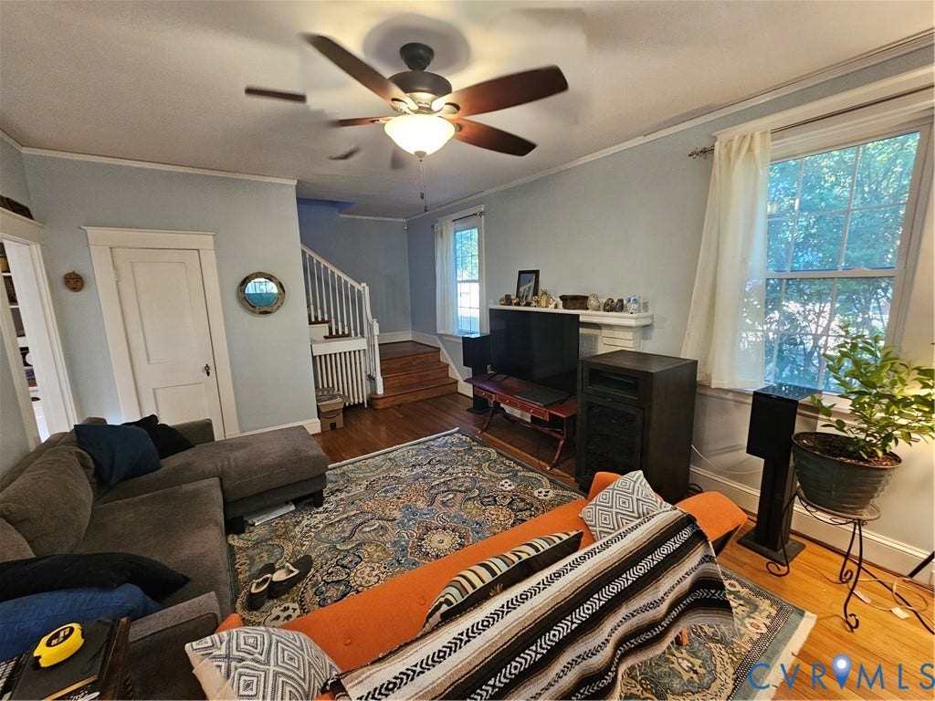 1206 Westminster Avenue, Richmond, VA 23227 Living area featuring wood-finish flooring, a ceiling fan with integrated lighting, multi-pane windows, and a classic fireplace mantel