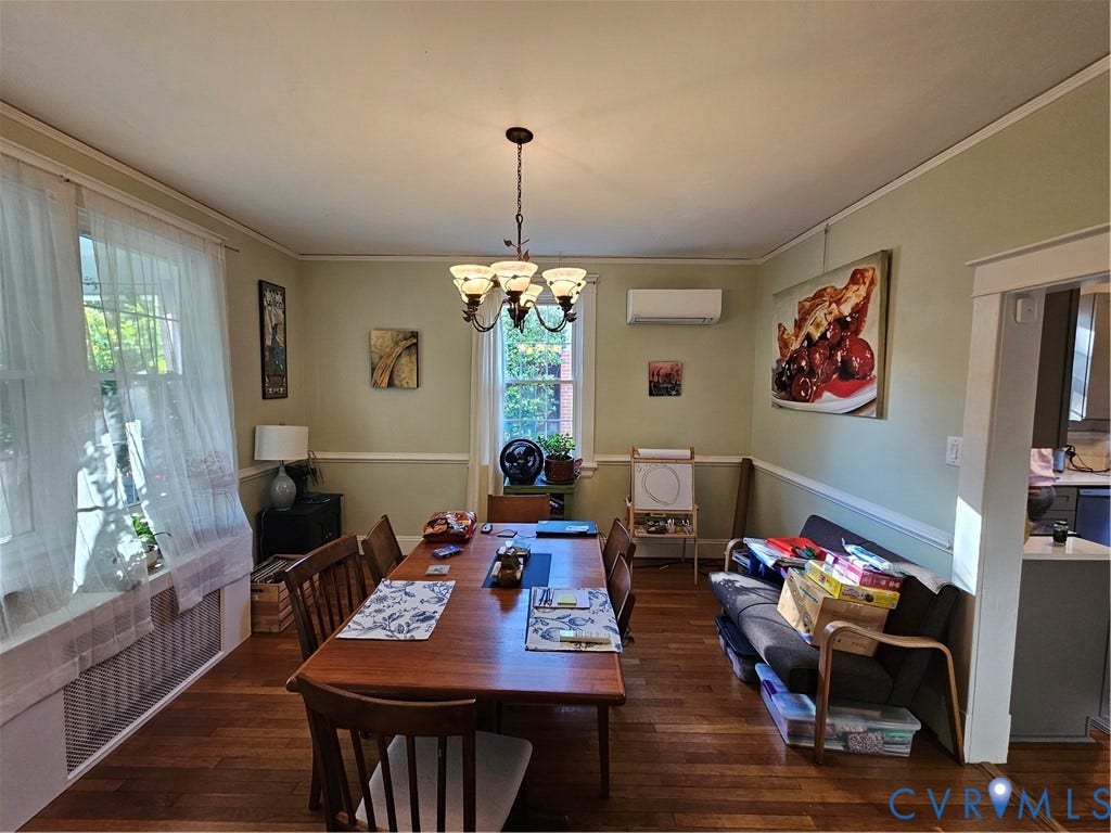 1206 Westminster Avenue, Richmond, VA 23227 Dining area featuring wood-finish flooring, chair rail molding, a multi-light chandelier, and a wall-mounted ductless climate control unit