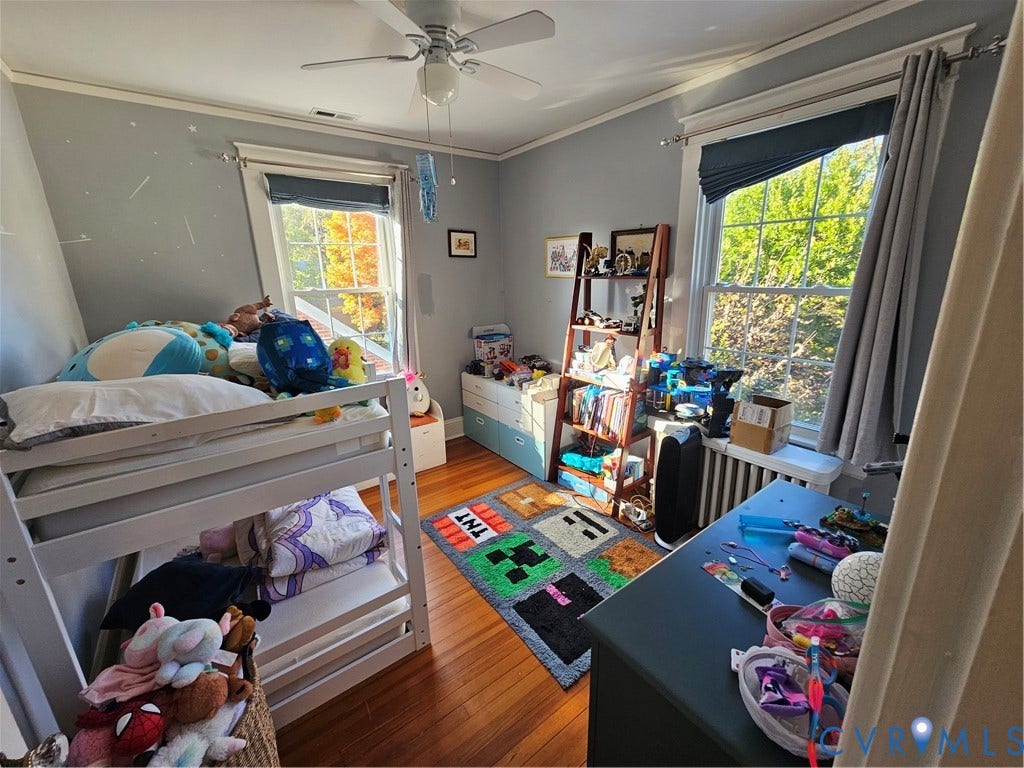 1206 Westminster Avenue, Richmond, VA 23227 Room featuring hardwood flooring, two double-hung windows with exterior trim, and a ceiling-mounted light fixture with fan