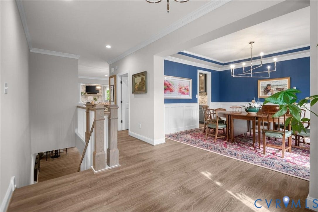 12168 Readers Pointe Drive, Readers Branch, Goochland, VA 23103 Wood-finish flooring, white wainscoting, multi-arm chandelier, and a wood-post staircase railing