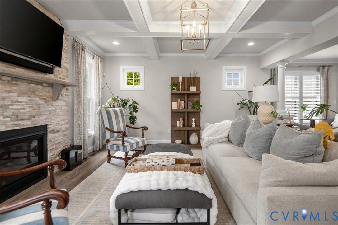 12168 Readers Pointe Drive, Readers Branch, Goochland, VA 23103 Coffered ceiling featuring recessed lighting and a central lantern-style pendant, stacked-stone fireplace surround, wood-finish flooring, and built-in shelving