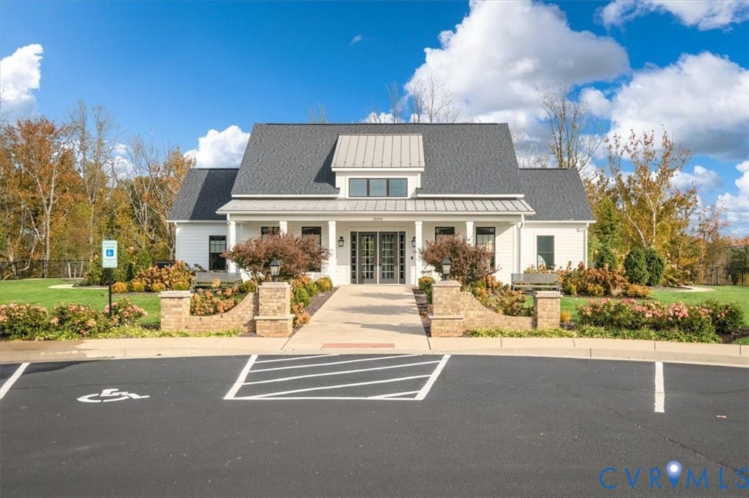 12168 Readers Pointe Drive, Readers Branch, Goochland, VA 23103 Single-story exterior featuring a metal-accented roof, symmetrical gable design, covered front porch, masonry piers, and concrete walkway