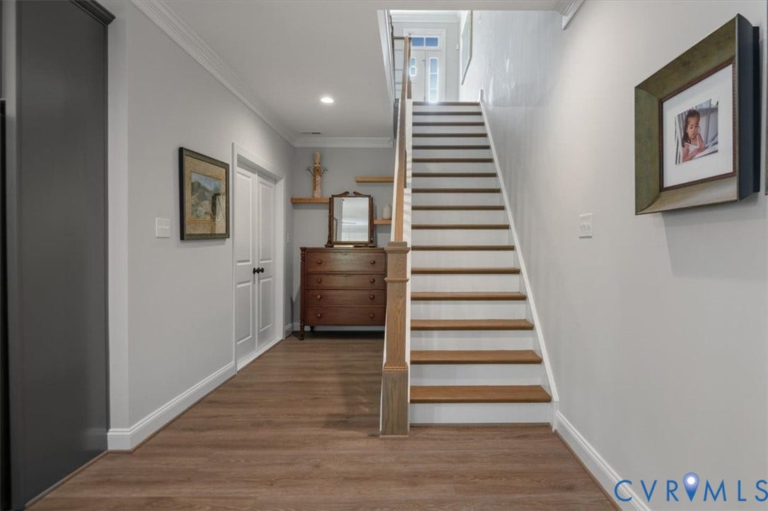 12168 Readers Pointe Drive, Readers Branch, Goochland, VA 23103 Terrace Level Foyer featuring wood-finish flooring, staircase with wood treads and white risers, decorative crown molding, and double panel interior doors