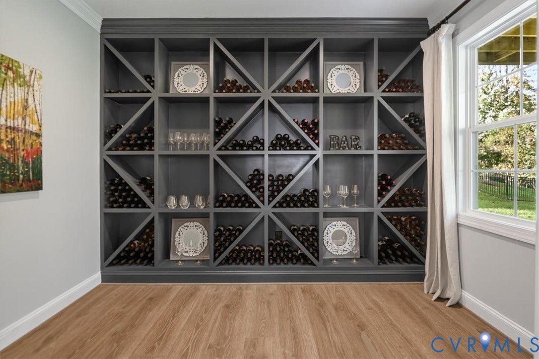 12168 Readers Pointe Drive, Readers Branch, Goochland, VA 23103 Terrace level - Floor-to-ceiling custom built-in wine storage featuring dark charcoal finish, X-pattern shelving, and wood-finish flooring