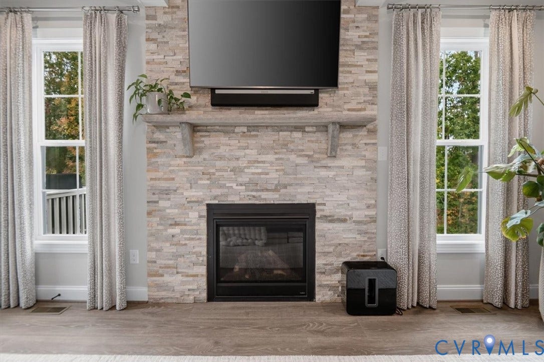 12168 Readers Pointe Drive, Readers Branch, Goochland, VA 23103 Floor-to-ceiling stacked stone fireplace featuring a substantial stone mantel and double-hung windows with exterior casing