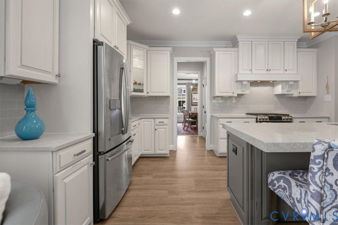 12168 Readers Pointe Drive, Readers Branch, Goochland, VA 23103 Kitchen featuring white cabinetry, center island with a stone-composite countertop, stainless steel appliances, tile backsplash, and wood-finish flooring