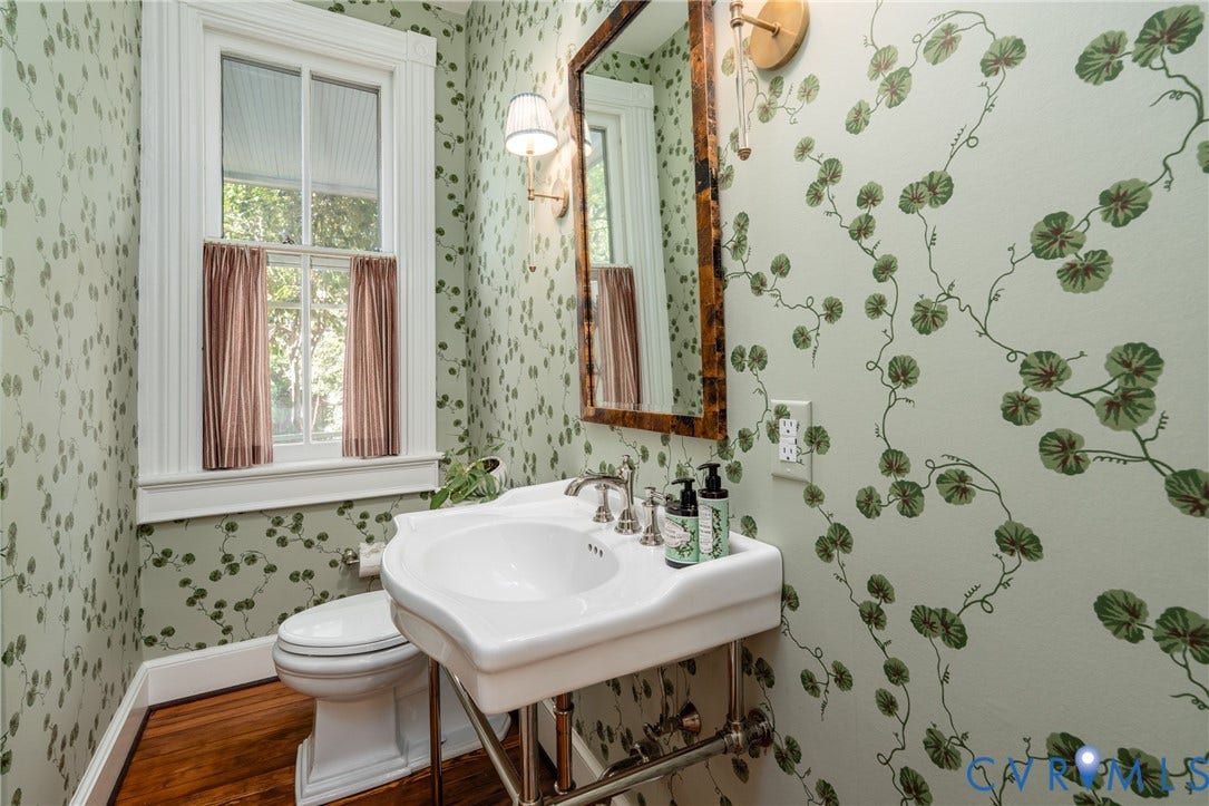 106 N Shields Avenue, The Fan, Richmond, VA 23220 Powder room redone in 2025 by Anne Pulliam Interiors, with botanical wallpaper and a console sink.