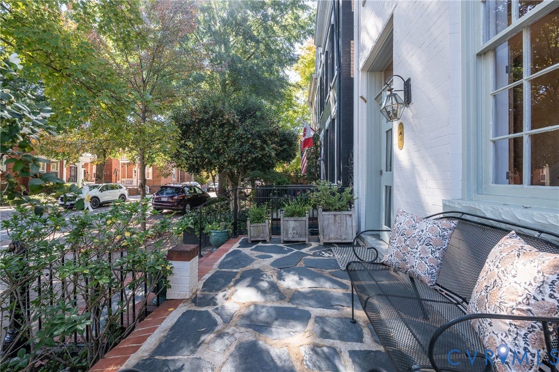 106 N Shields Avenue, The Fan, Richmond, VA 23220 Flagstone front porch behind the iron fence, with room for seating and planters.
