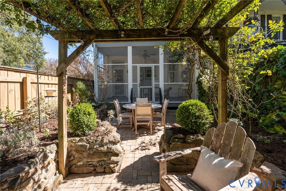 106 N Shields Avenue, The Fan, Richmond, VA 23220 Seating under the pergola, with the screened porch beyond.