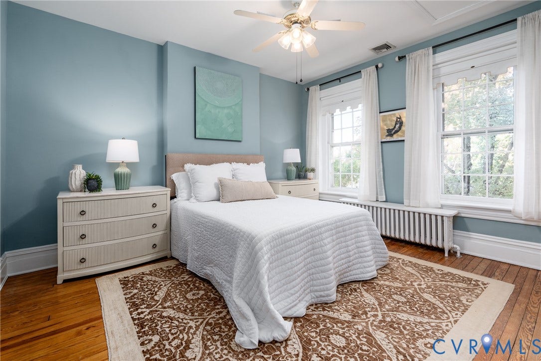 106 N Shields Avenue, The Fan, Richmond, VA 23220 Primary bedroom with 3 front windows and hardwood floors.