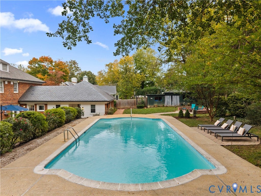 1203 Rothesay Circle, Windsor Farms, Richmond, VA 23221 In-ground swimming pool with stone coping, expansive concrete pool deck, mature trees, and brick exterior residence