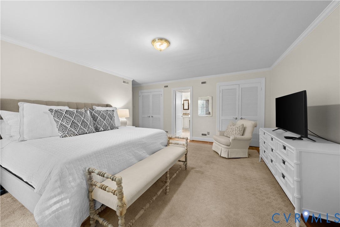1203 Rothesay Circle, Windsor Farms, Richmond, VA 23221 Neutral-toned bedroom featuring crown molding, carpeting, and dual-closet storage with louvered doors