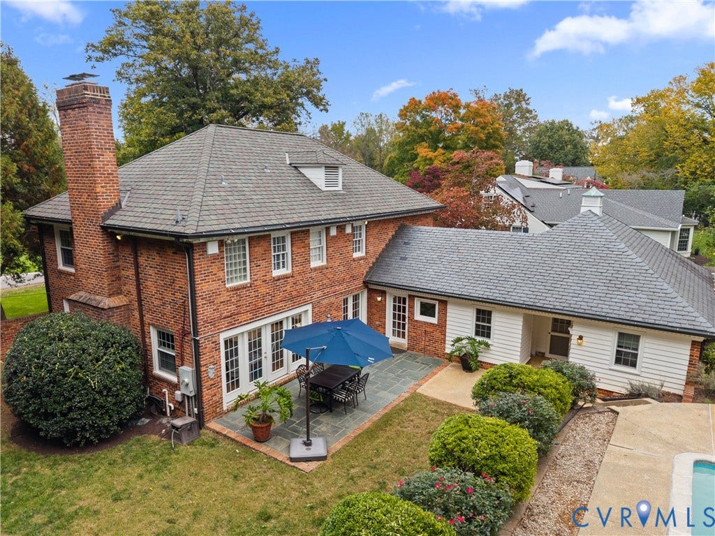 1203 Rothesay Circle, Windsor Farms, Richmond, VA 23221 Brick exterior featuring a multi-gabled roof, exterior masonry chimney, flagstone patio, and white horizontal siding