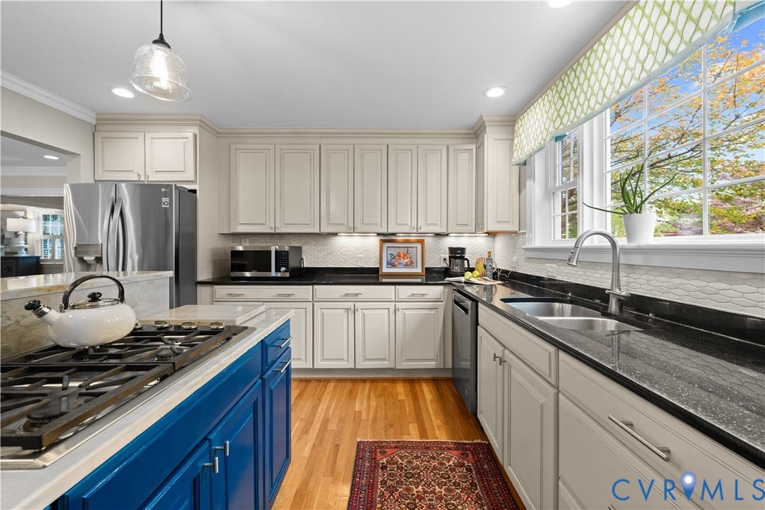 1203 Rothesay Circle, Windsor Farms, Richmond, VA 23221 Kitchen featuring off-white cabinetry, dark stone countertops, wood-finish flooring, a blue-finished center island with an integrated cooktop, and stainless steel appliances