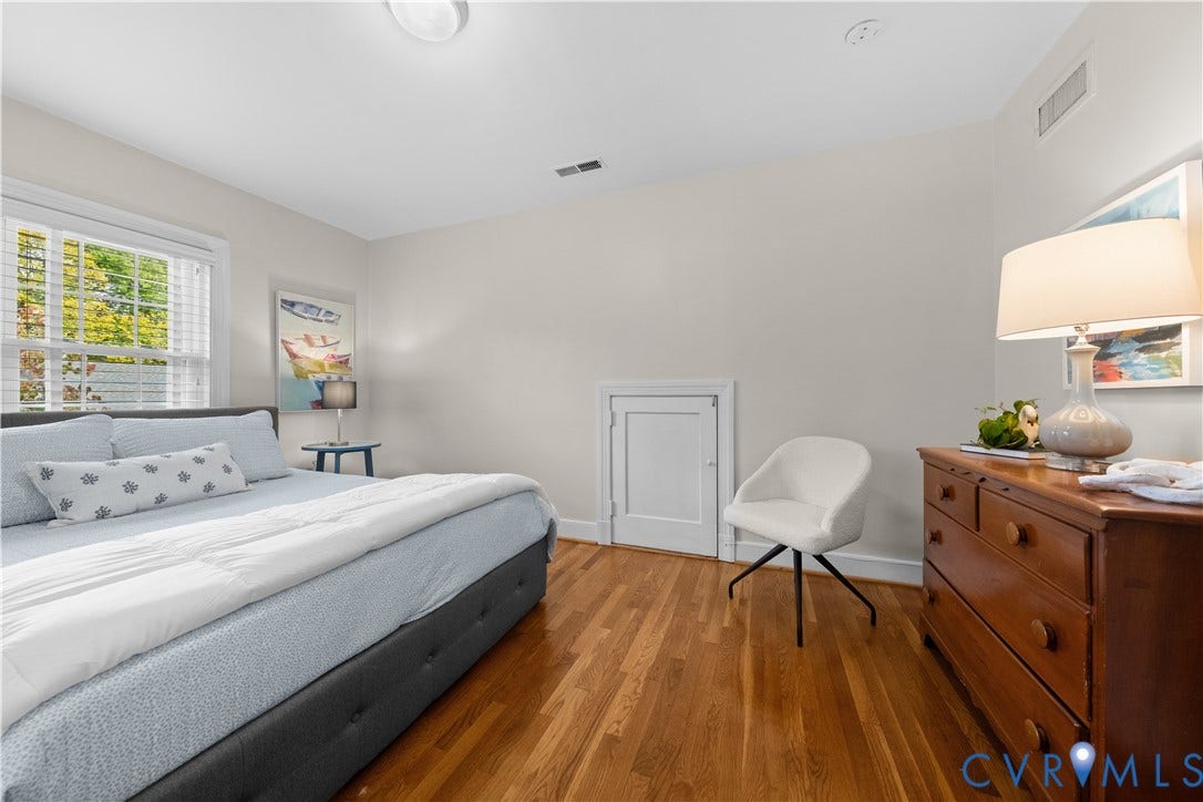1203 Rothesay Circle, Windsor Farms, Richmond, VA 23221 Bedroom featuring wood-finish flooring, neutral wall paint, multi-pane window with white trim, and built-in access panel
