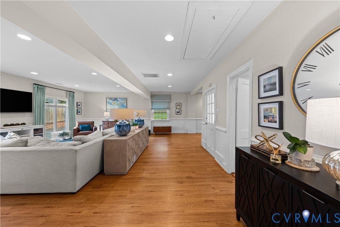 1203 Rothesay Circle, Windsor Farms, Richmond, VA 23221 Open-concept living space featuring wood-finish flooring, recessed lighting, and crisp white wainscoting