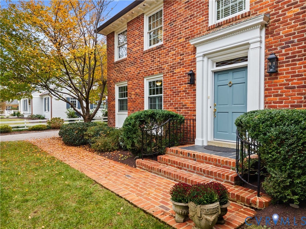 1203 Rothesay Circle, Windsor Farms, Richmond, VA 23221 Traditional brick exterior featuring a classical architectural pediment over the entryway, multi-pane windows, a detailed transom, and a laid-brick walkway