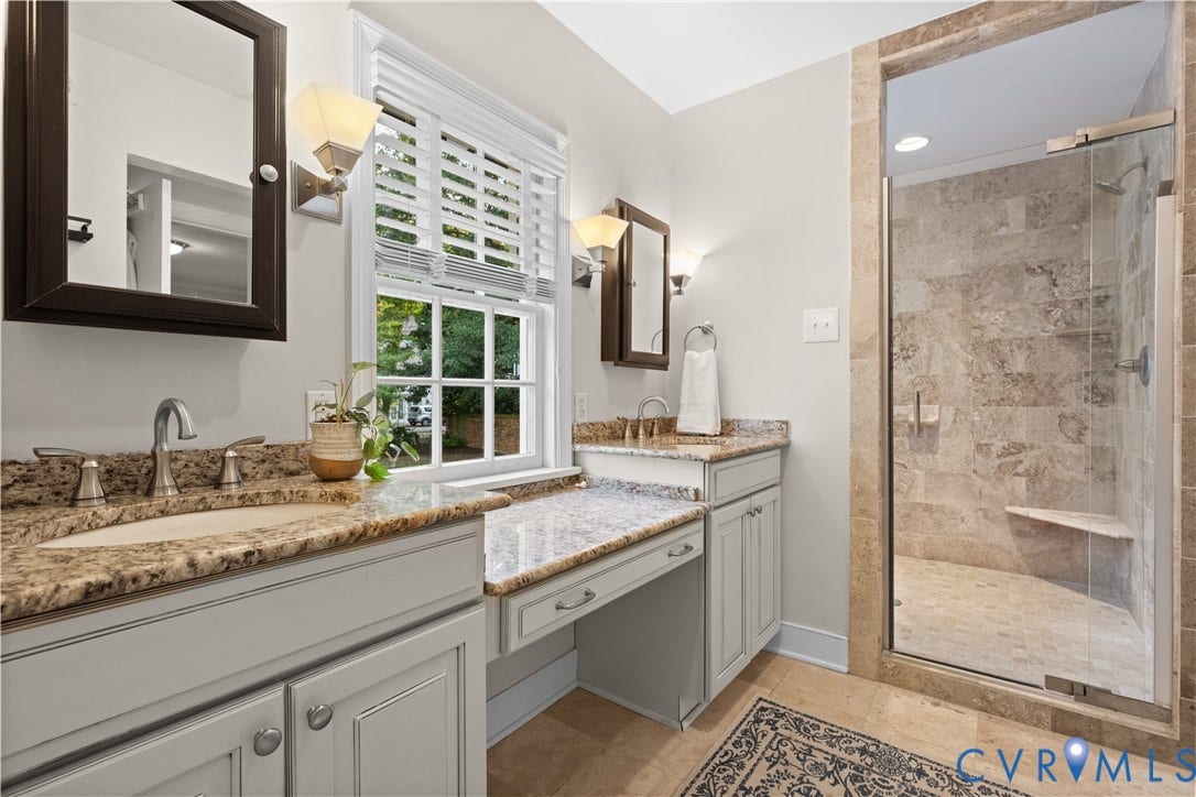 1203 Rothesay Circle, Windsor Farms, Richmond, VA 23221 Dual vanity with stone-surface countertops, walk-in shower featuring glass enclosure and stone-tile surround, and built-in vanity station with cabinetry
