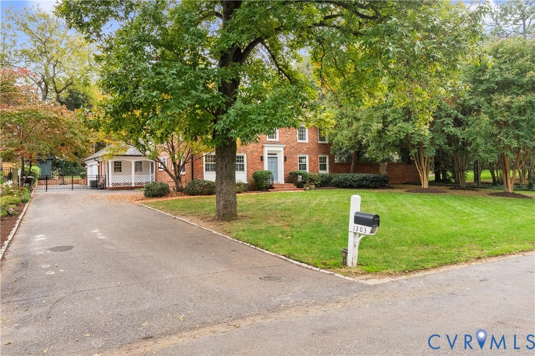 1203 Rothesay Circle, Windsor Farms, Richmond, VA 23221 Two-story brick exterior featuring a covered porch, paved driveway, mature trees, and landscaping