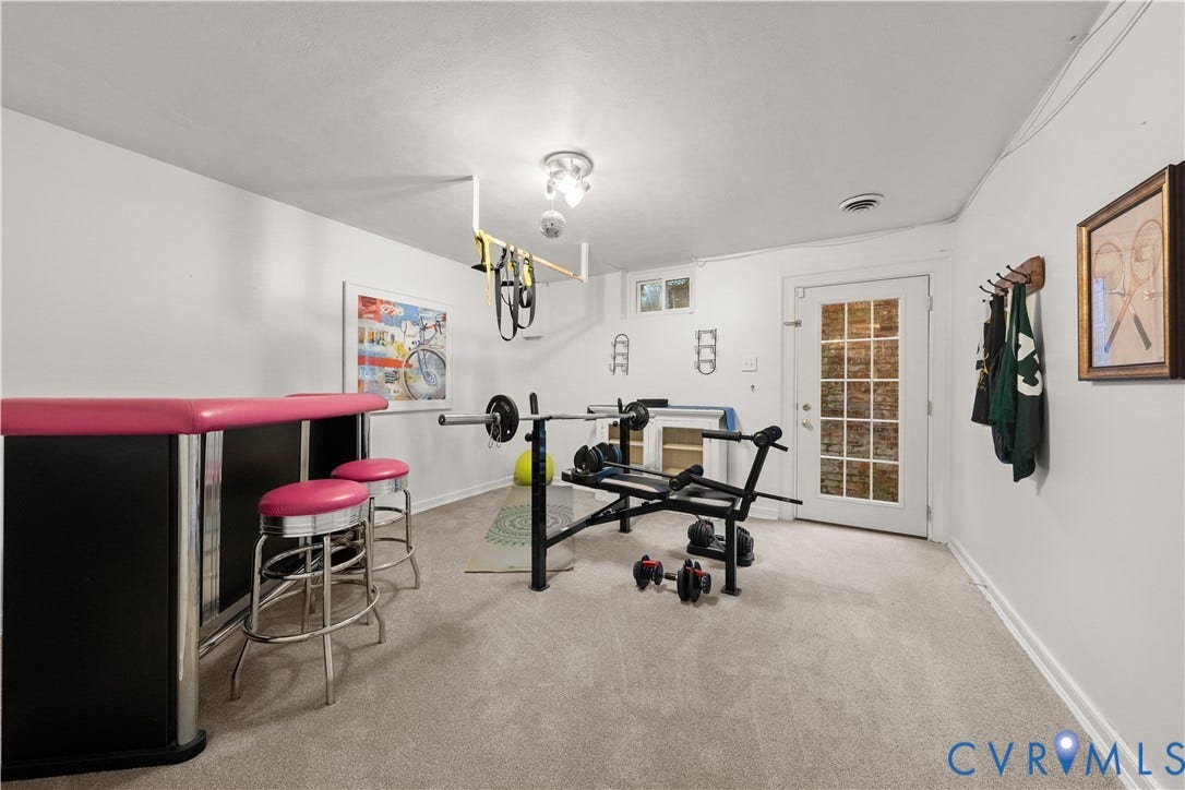 1203 Rothesay Circle, Windsor Farms, Richmond, VA 23221 Neutral-toned room featuring neutral carpeting, a multi-light ceiling fixture, and a white exterior door with glass pane detailing
