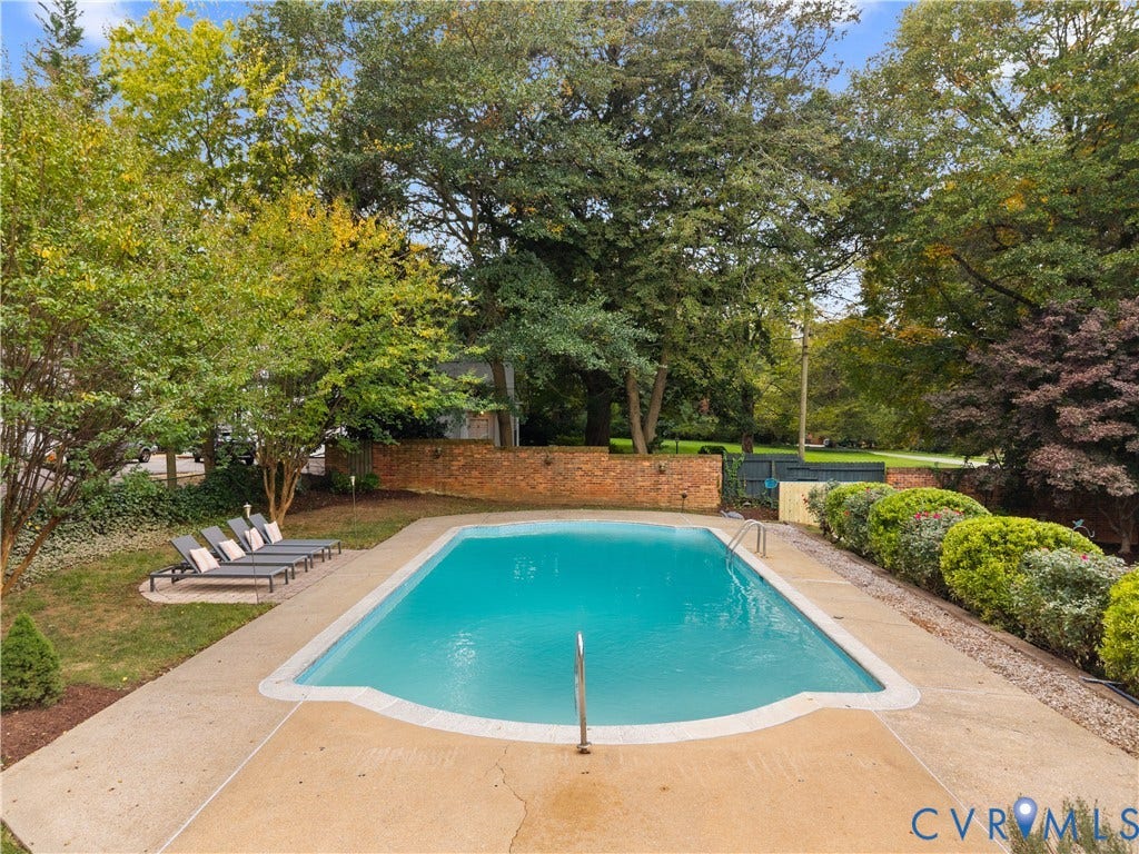 1203 Rothesay Circle, Windsor Farms, Richmond, VA 23221 Inground swimming pool with metal ladder, concrete surround, brick privacy wall, and mature landscaping