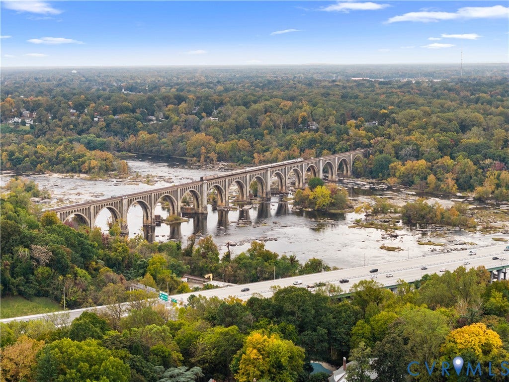 1203 Rothesay Circle, Windsor Farms, Richmond, VA 23221 Aerial perspective featuring a river, mature forest canopy, and a stone arch bridge