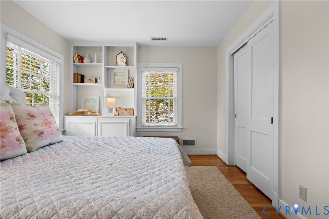 1203 Rothesay Circle, Windsor Farms, Richmond, VA 23221 Built-in white shelving, wood flooring, multi-pane windows with horizontal blinds, and a dual-panel sliding closet door