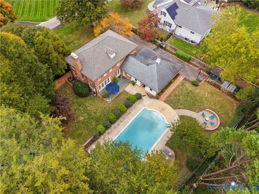 1203 Rothesay Circle, Windsor Farms, Richmond, VA 23221 Brick exterior residence featuring an inground swimming pool, stone patio, circular hardscaped seating area, and established trees on the grounds