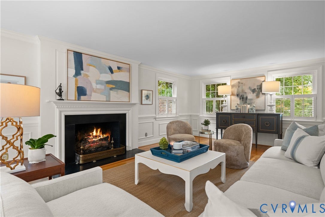 1203 Rothesay Circle, Windsor Farms, Richmond, VA 23221 Living area featuring a fireplace with a detailed mantel, wainscoting, wood-finish flooring, and multiple windows with shutters