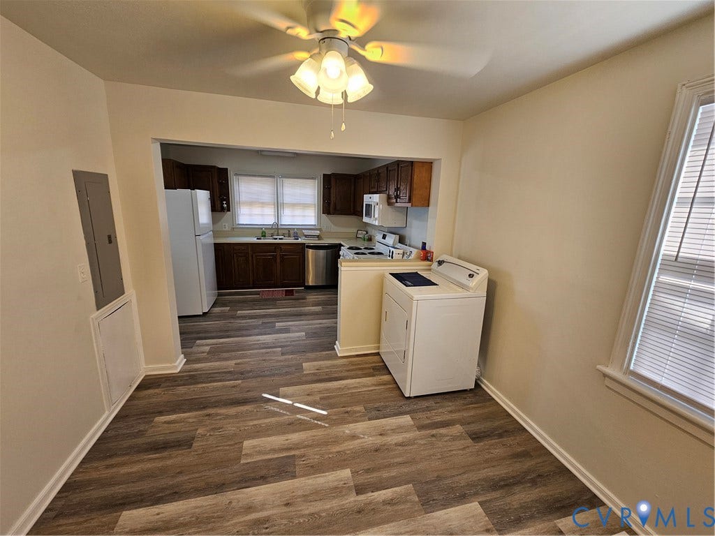 1112 E 15th Street, Richmond, VA 23224 Wood-finish flooring throughout, kitchen featuring dark wood cabinetry, stainless steel dishwasher, integrated sink, and ceiling-mounted light fixture