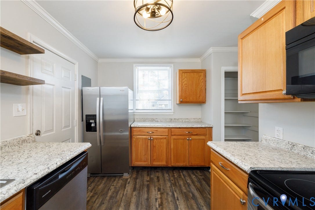 1010 E 17th Street, Oak Grove, Richmond, VA 23224 Kitchen featuring natural wood cabinetry, stone-patterned countertops, wood-finish flooring, stainless steel appliances, and a built-in pantry with shelving