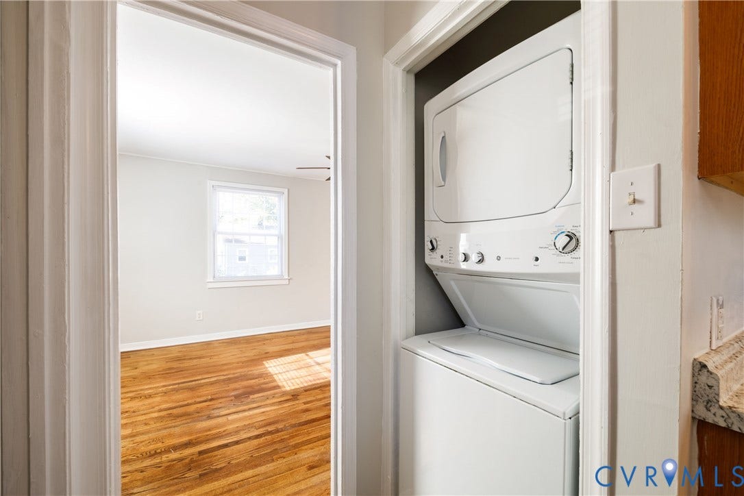 1010 E 17th Street, Oak Grove, Richmond, VA 23224 Built-in stacked laundry unit, wood-finish flooring, and natural light from a double-hung window