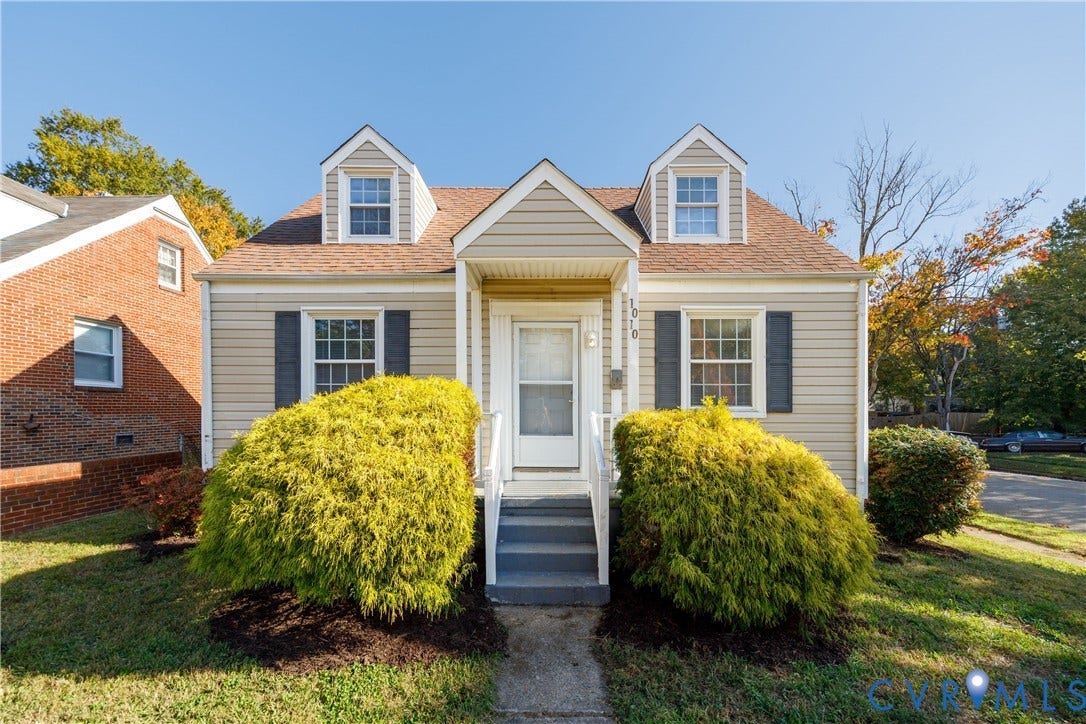 1010 E 17th Street, Oak Grove, Richmond, VA 23224 Cape Cod exterior featuring horizontal siding, dual dormer windows, a central gable entrance, and decorative window shutters
