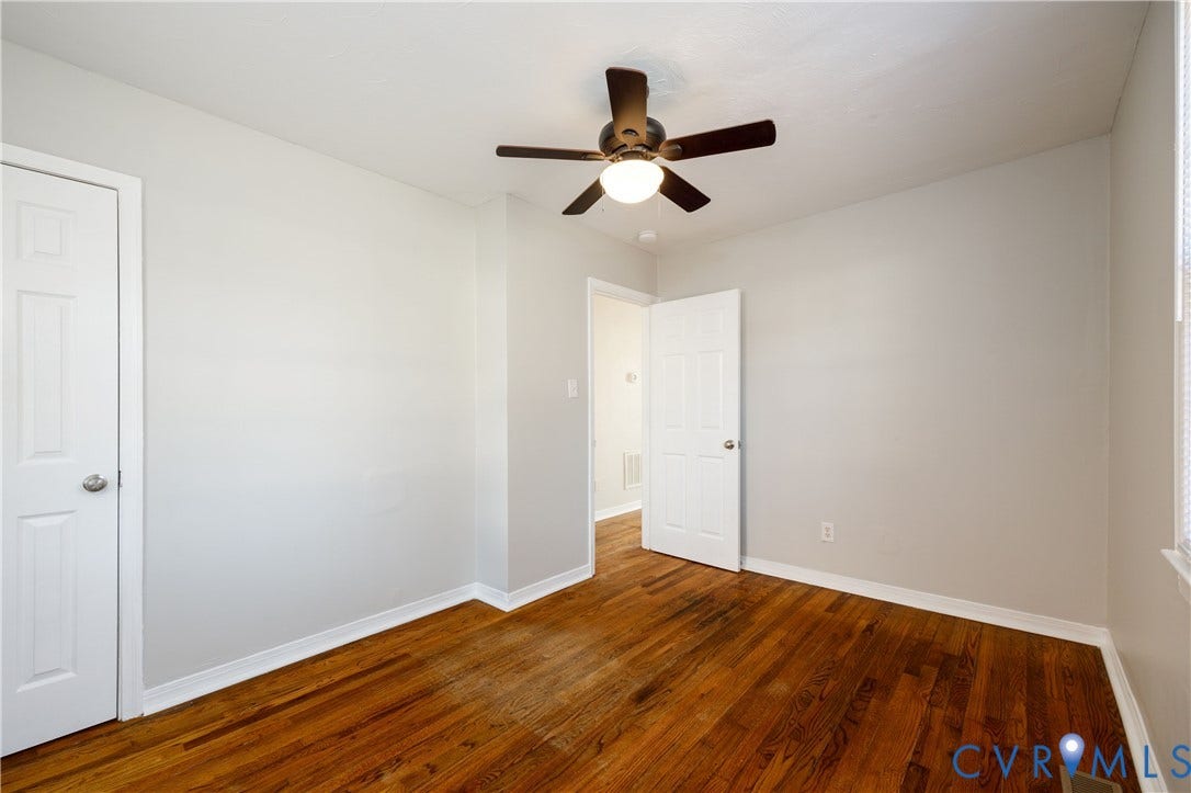 1010 E 17th Street, Oak Grove, Richmond, VA 23224 Room featuring wood-finish flooring, six-panel interior doors, and a ceiling-mounted light fixture with a fan