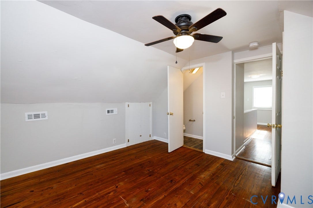 1010 E 17th Street, Oak Grove, Richmond, VA 23224 Room featuring wood-finish flooring, sloped ceilings, a ceiling fan with integrated lighting, and built-in under-eave storage
