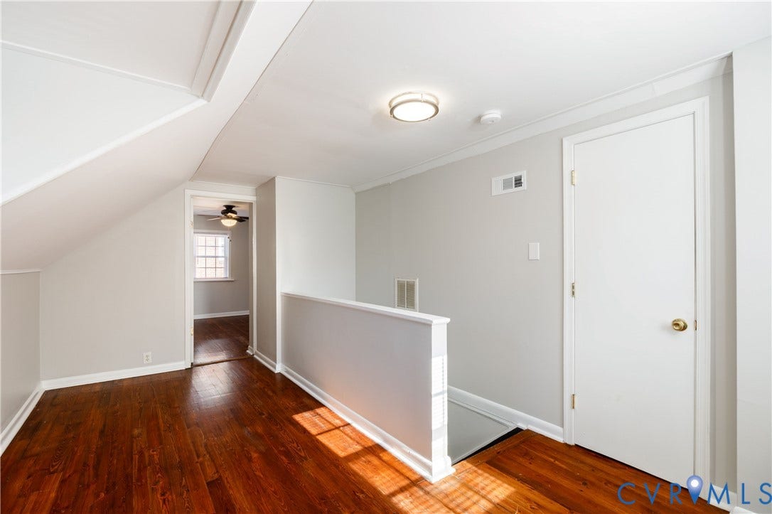 1010 E 17th Street, Oak Grove, Richmond, VA 23224 Wood-finish flooring, neutral wall tones, sloped ceiling architecture, and flush-mount ceiling lighting