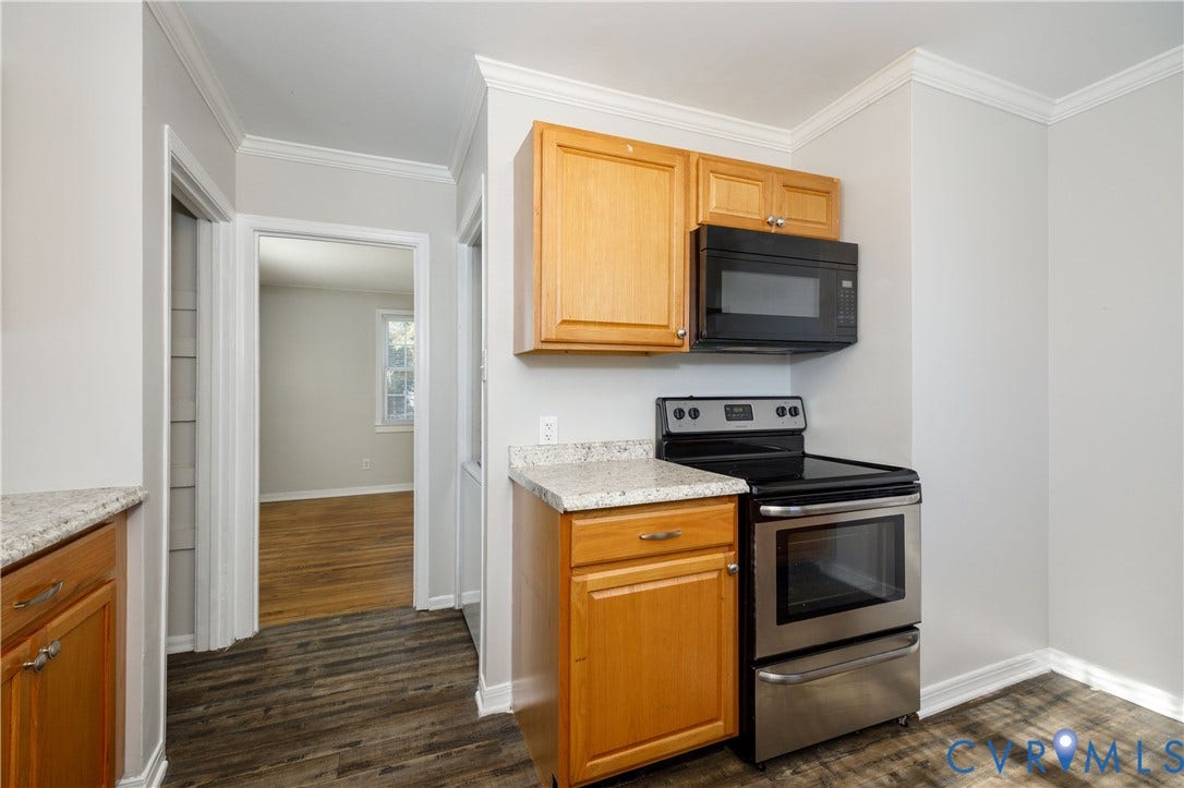 1010 E 17th Street, Oak Grove, Richmond, VA 23224 Kitchen featuring wood cabinetry, stone-finish countertops, stainless steel range, and over-the-range microwave, with wood-finish flooring